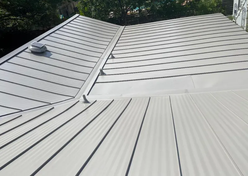 Solar attic fan installed on a metal roof for Roof Ventilation in Babylon